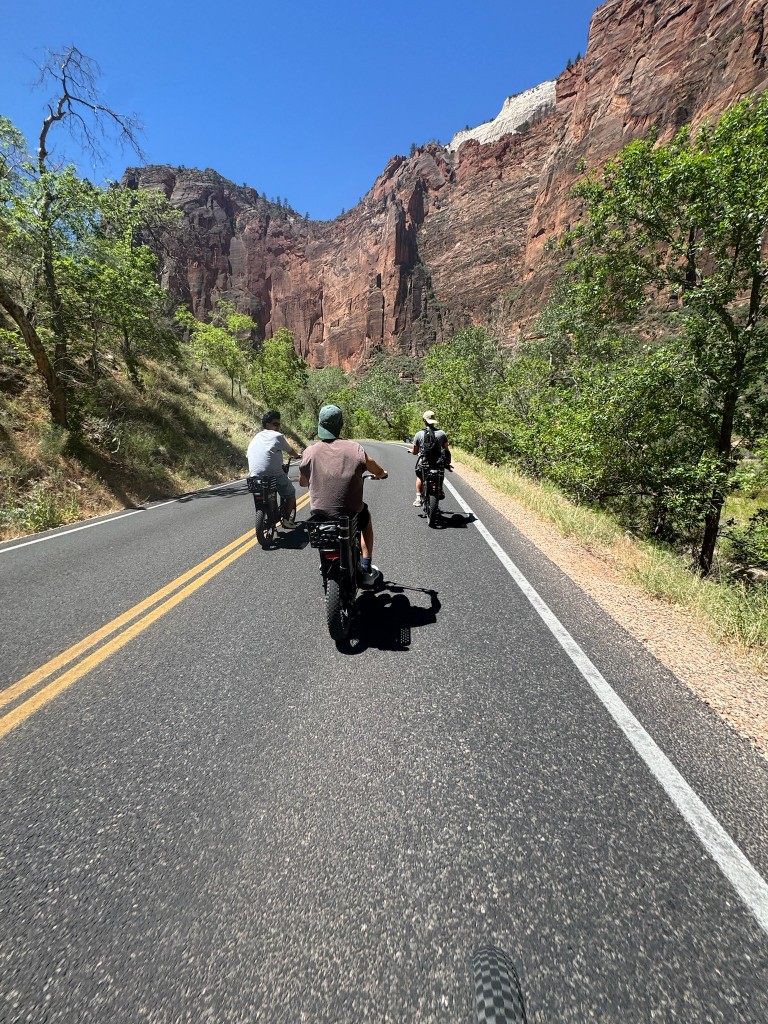 Riding e-bikes through a canyon road